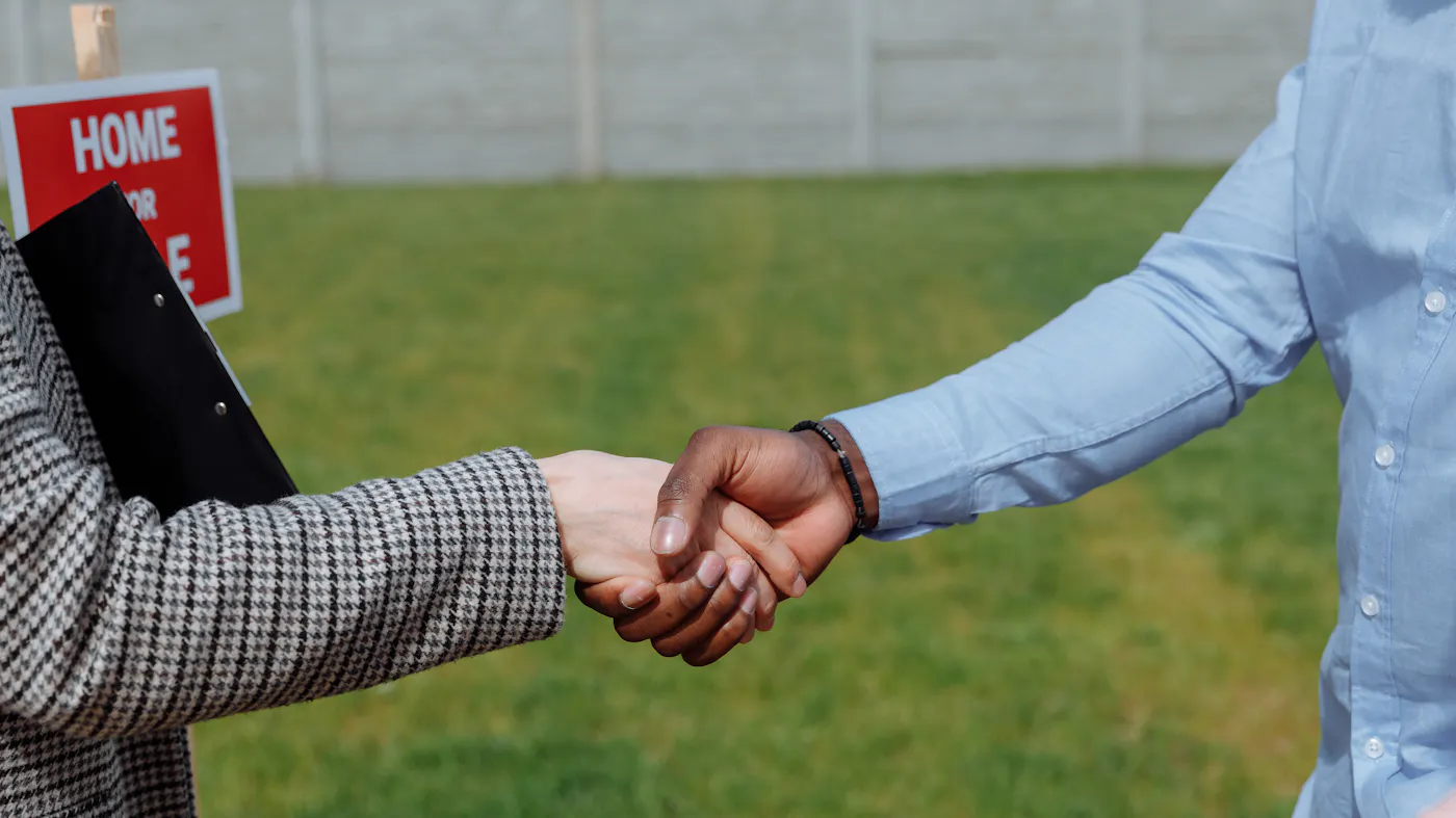 A handshake after closing a cash offer for a home in Austin Texas