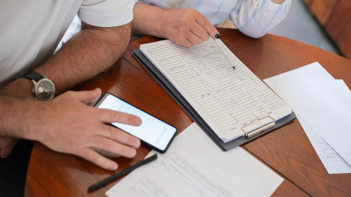 Heirs reviewing estate documents at a table while deciding how to sell an inherited home fast in Texas