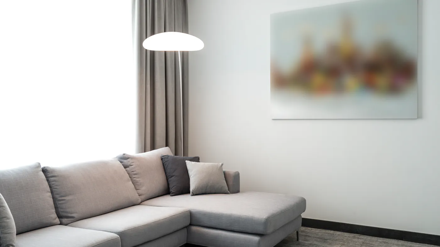 A staged modern living room with a neutral gray sofa — the prep that helps sell a home quick